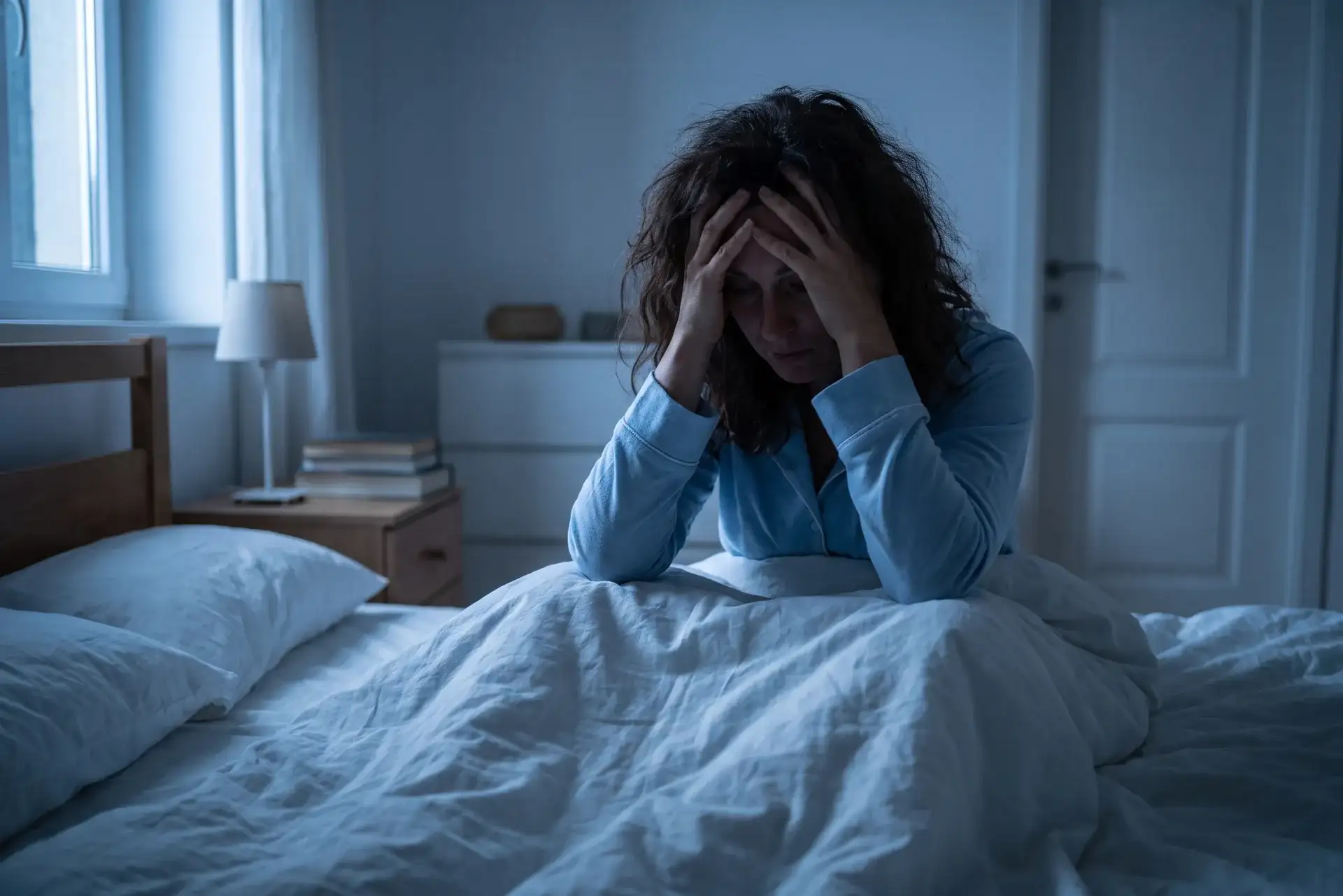 Woman awake in bed with insomnia treated by sleep medicine in Houston